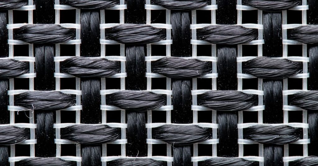Detailed view of a black and white woven textile pattern in macro photography.