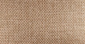 Detailed close-up of beige fabric texture, highlighting its woven pattern.