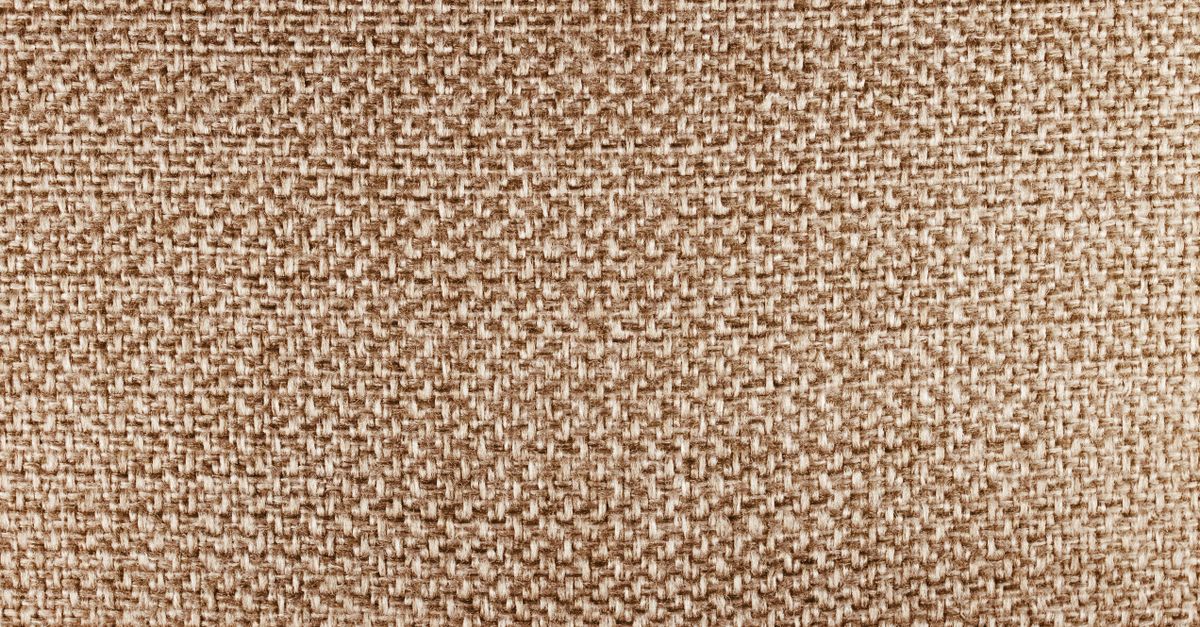 Detailed close-up of beige fabric texture, highlighting its woven pattern.