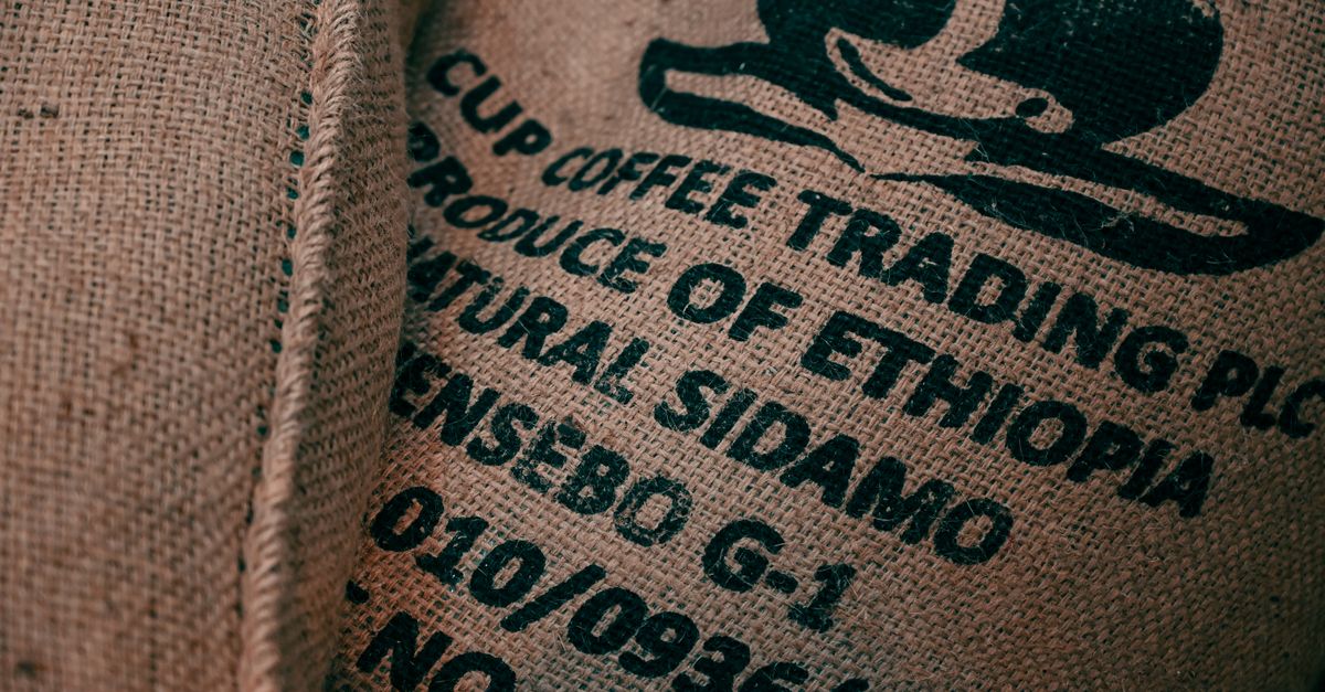 Close-up of burlap sack with Ethiopian coffee logo and text, showcasing texture.
