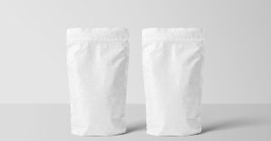 Two white paper stand-up pouches for packaging mockup on a clean surface.