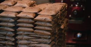 Stacked brown paper packages in an industrial warehouse setting. Perfect for logistics visuals.