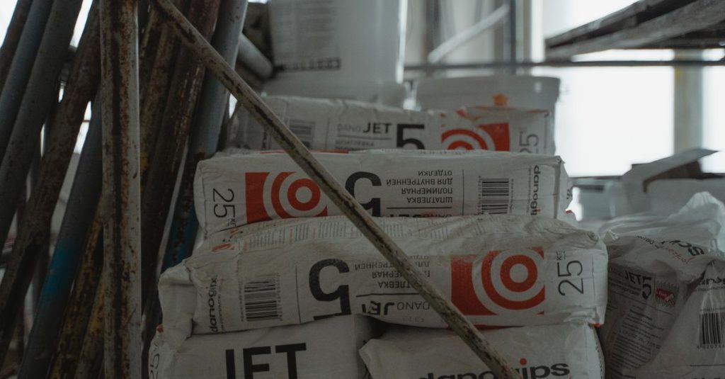 Sacks of cement placed in an indoor construction area, showcasing renovation materials.