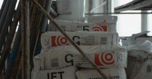 Sacks of cement placed in an indoor construction area, showcasing renovation materials.